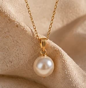 A single pearl on a delicate golden chain